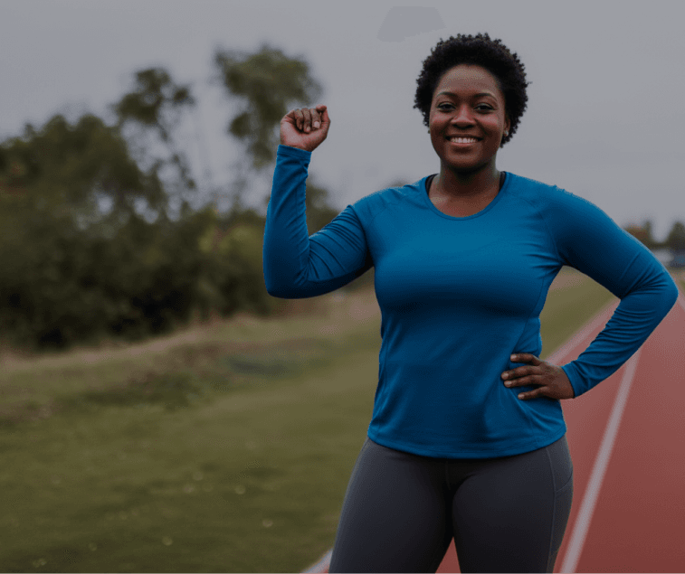 Woman celebrating on a running track