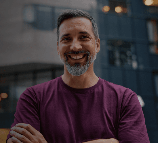 Man smiling with arms crossed